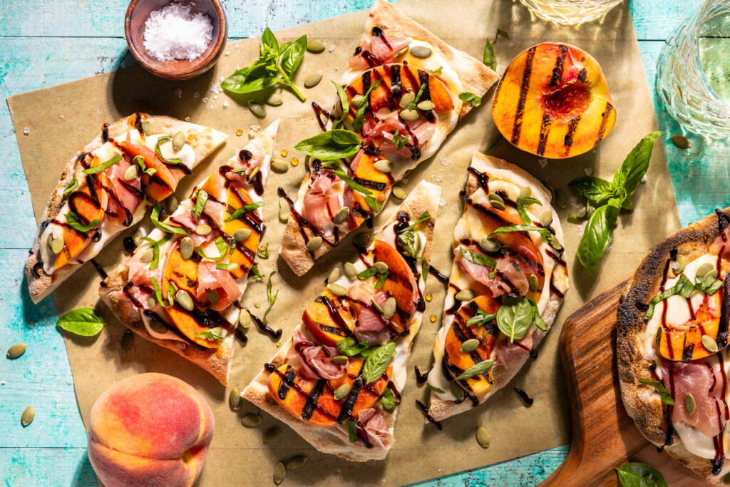 Grilled Peach & Prosciutto Flatbread. Juicy, grilled summer peaches are the star of this perfect party appetizer! Shortcut the dough with a frozen, store-bought version to make this recipe a breeze.