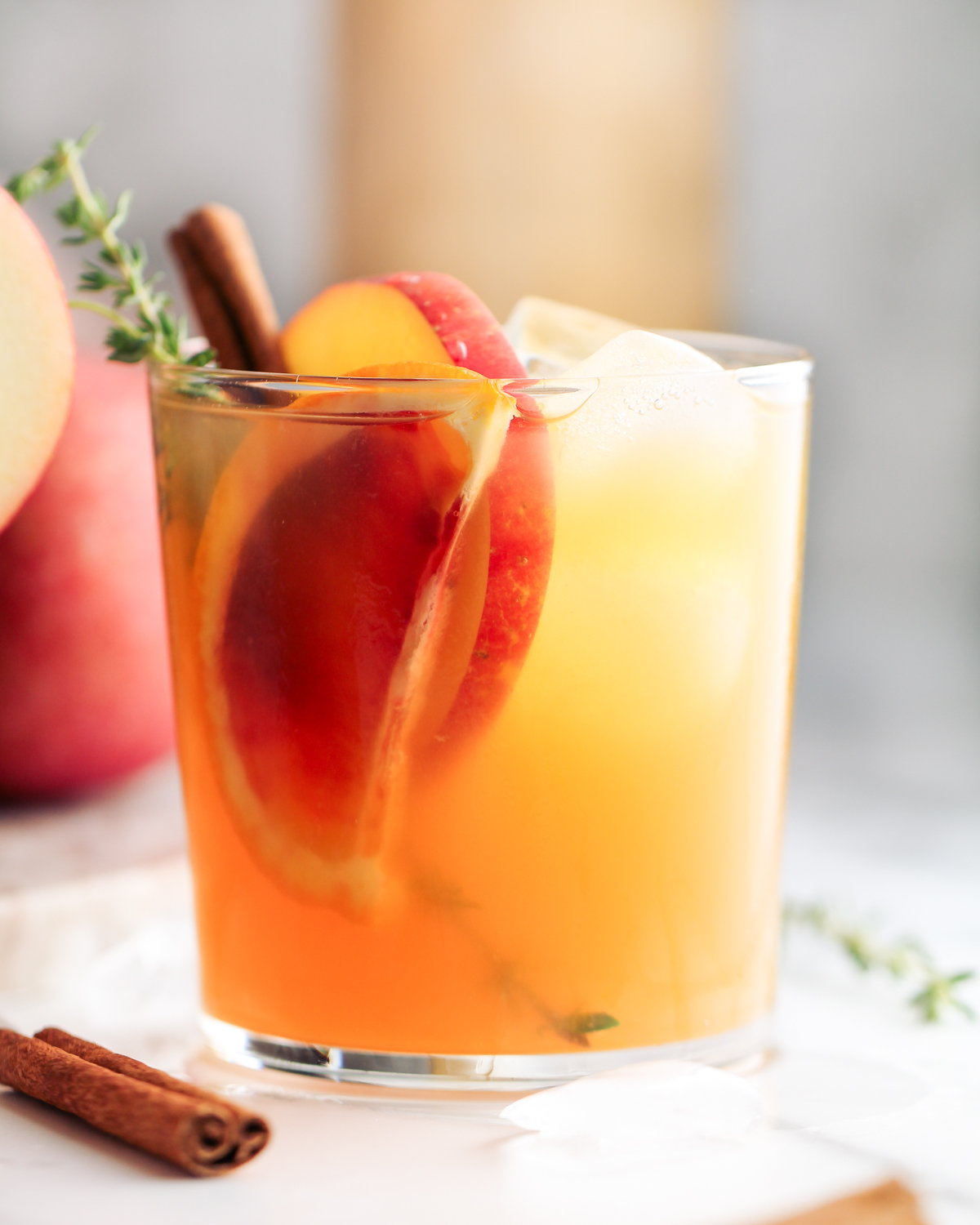 Ready for a taste of fall in a glass? This big batch Harvest Apple Ginger Cocktail featuring apple cider, ginger beer, gin, and autumn herbs and spices is it!