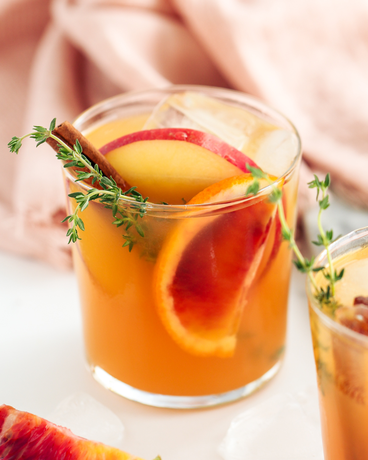 Ready for a taste of fall in a glass? This big batch Harvest Apple Ginger Cocktail featuring apple cider, ginger beer, gin, and autumn herbs and spices is it!