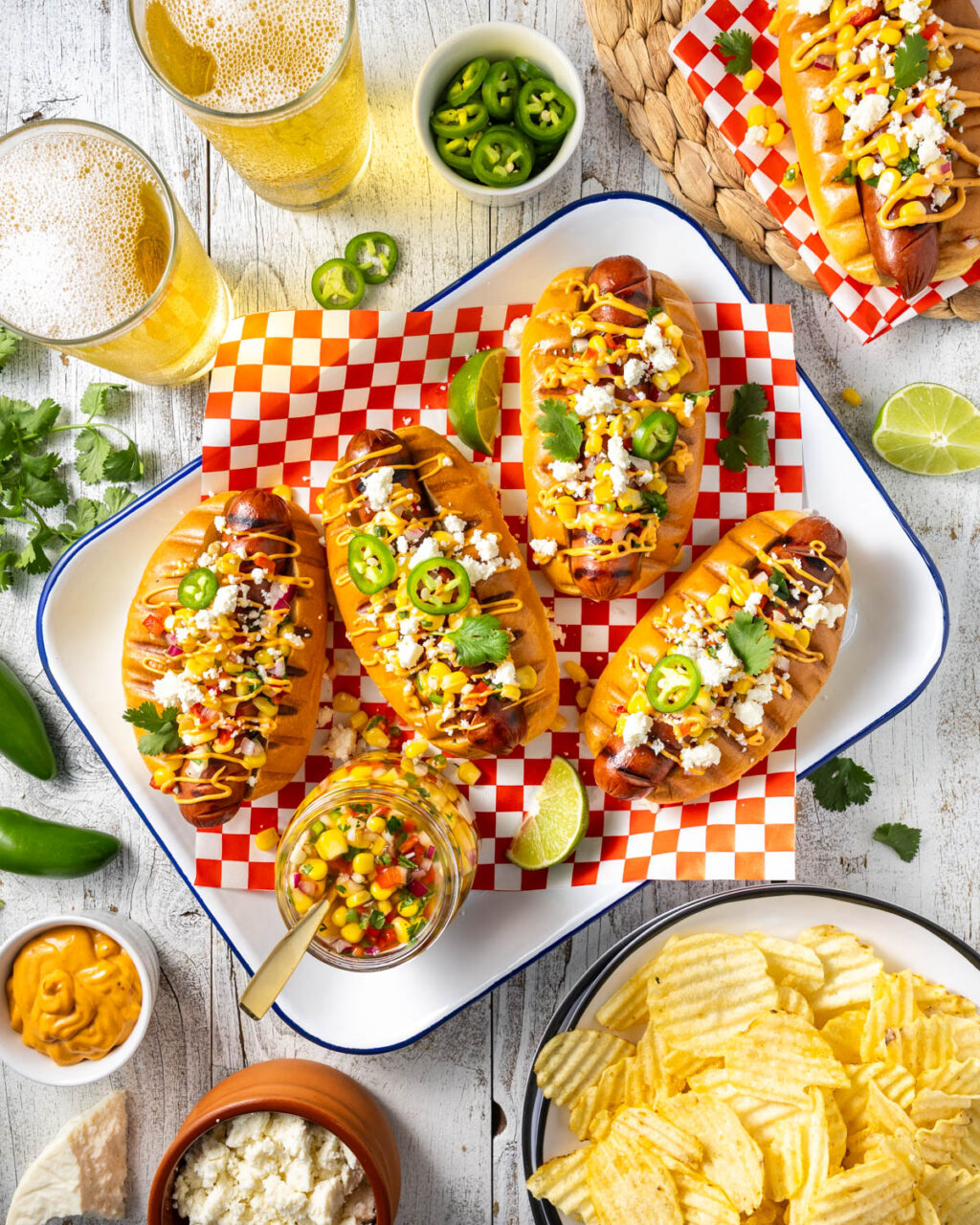 Grilled hot dogs with pickled corn relish, chipotle mayo, and queso fresco. Grill these up for your next barbecue - a great meal to share with friends!
