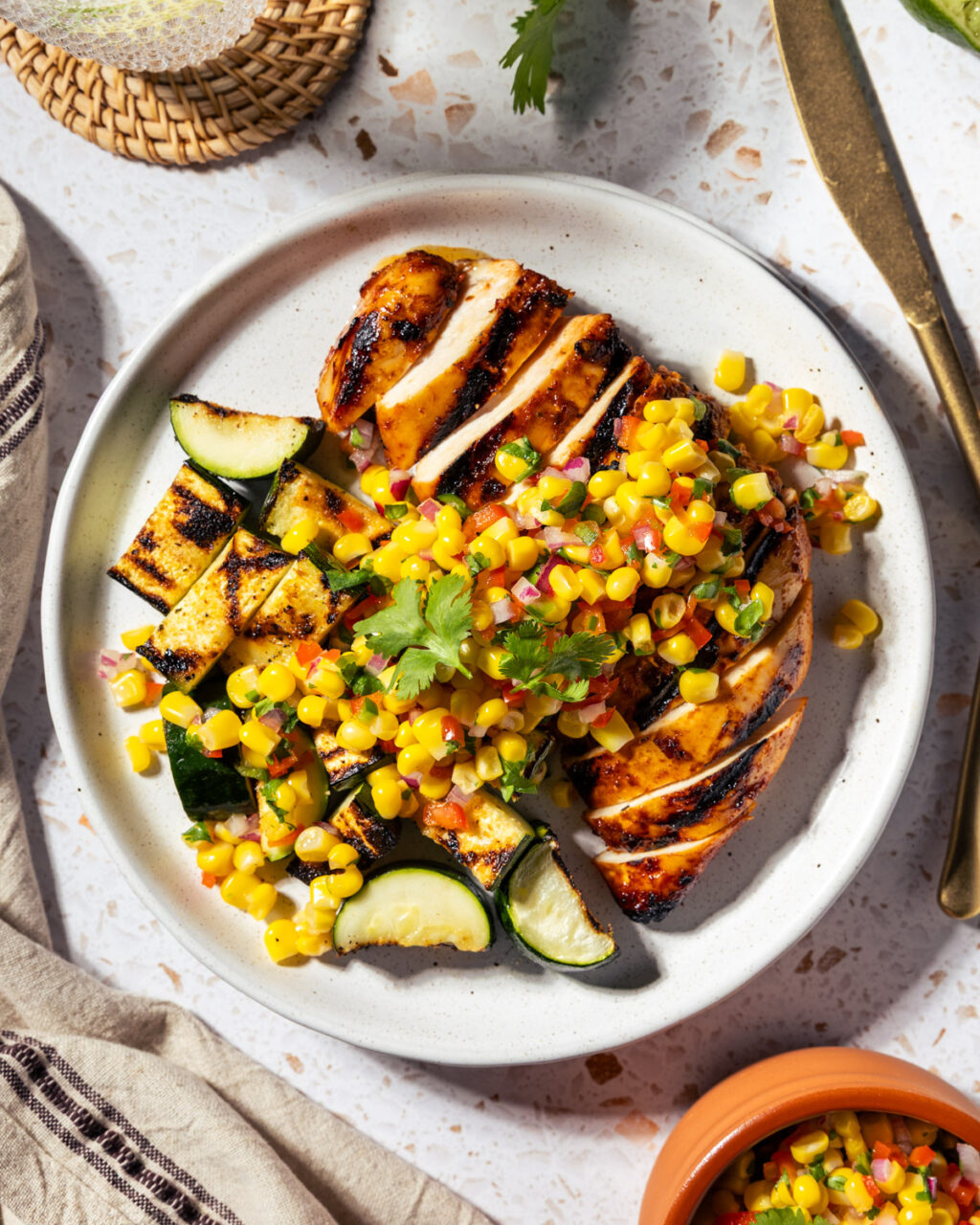 Grilled Adobo Chicken with Pickled Corn Relish and grilled zucchini. Perfect for your next barbecue or meal prep!