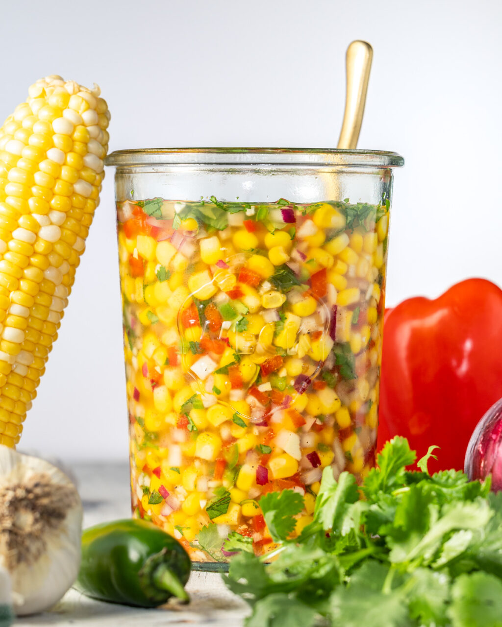 Pickled corn relish in a jar. Perfect for serving over grilled meats and veggies. Makes a great side or salsa for your next barbecue or meal prep.