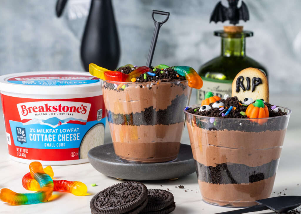 Cottage cheese dirt pudding cups with gummy worms, sprinkles, and eyeball candies.