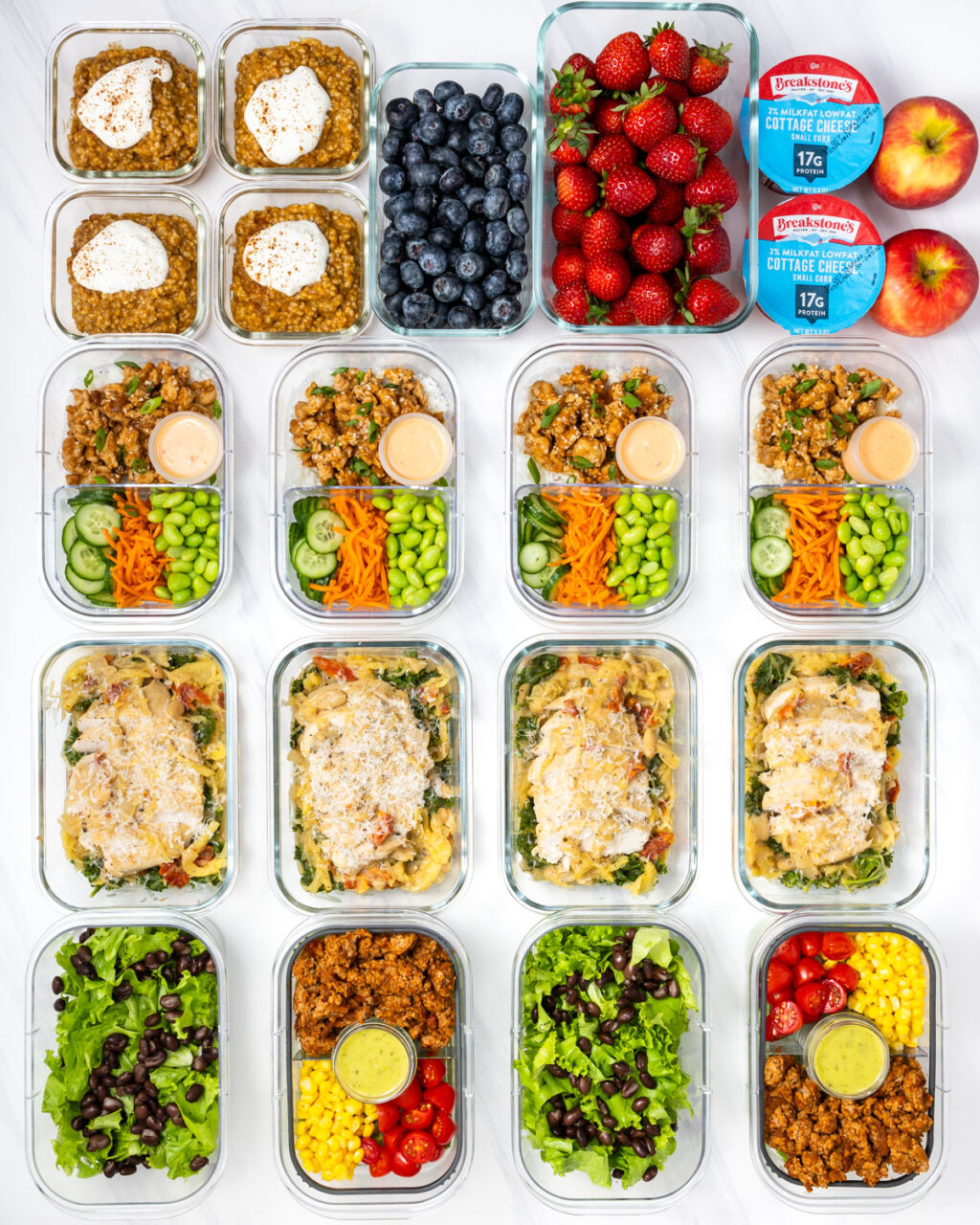 Meal prepped high protein meals for one week lined up on a bright countertop